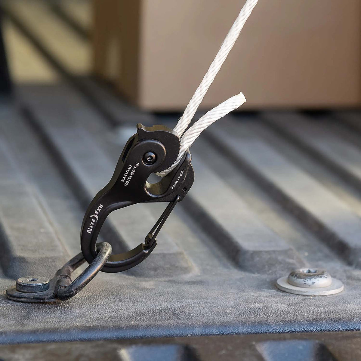 In-Use Image of the Nite Ize CamJam XT Aluminum Rope Tightener with 10' Rope.