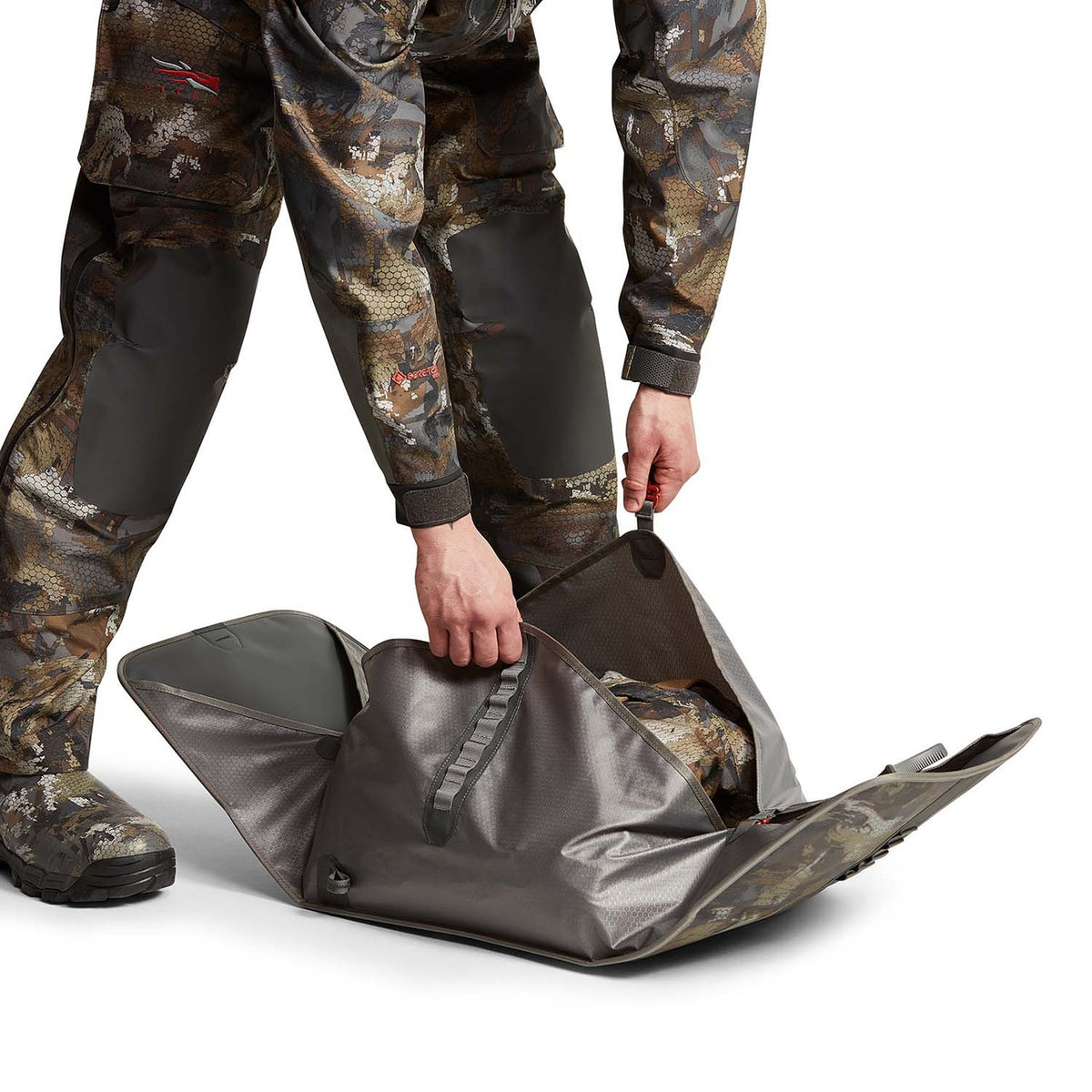 Folding Up Image of the Sitka Wader Storage Bag.
