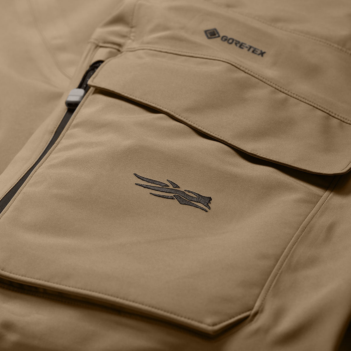 Sitka Hudson Bib Closeup Front Pocket Image in Dirt