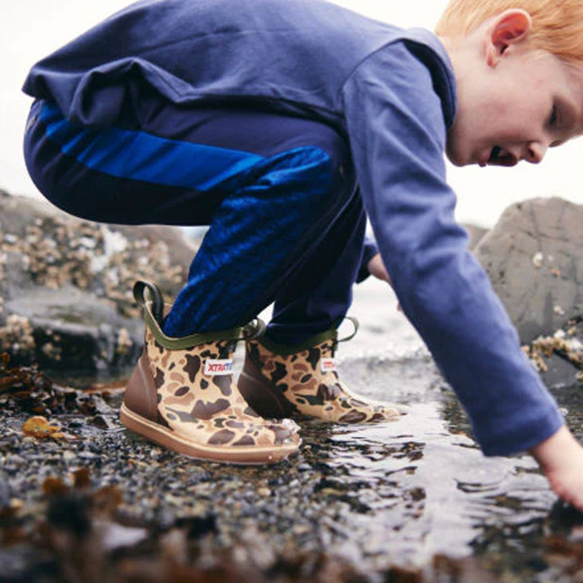 Model Image of the Xtratuf Kids' Ankle Sport Deck Boots.
